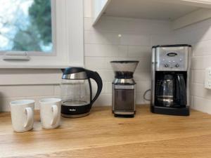 a counter with two coffee cups and a coffee maker at Phinneywood Cottage - Greenlake - Zoo - Phinney in Seattle