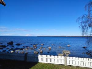a large body of water with a white fence at Lainela puhkeküla in Käsmu