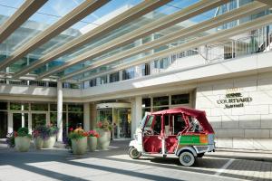 a small golf cart parked in front of a building at Courtyard by Marriott Hannover Maschsee in Hannover