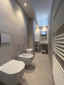 a bathroom with a white toilet and a sink at Residenza Clelia Riccione in Riccione