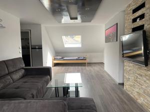 a living room with a couch and a table at Ferienwohnung in Essen in Essen