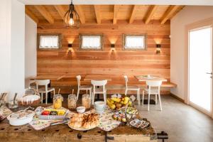 a dining room with a table with food on it at Agriturismo al Comarel in Tarzo