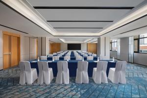 Fairfield by Marriott Danyang في Danyang: قاعة اجتماعات مع طاولة زرقاء وكراسي بيضاء