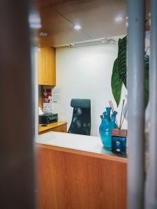 an office counter with a blue vase on top of it at Hotel Mar Azul in Espinho