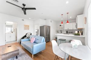 a living room with a blue couch and a table at Luxe East Downtown 3BR Condo, Walk to Bars, Restaurants, Shops in Austin