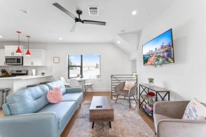 a living room with a couch and a table at Luxe East Downtown 3BR Condo, Walk to Bars, Restaurants, Shops in Austin