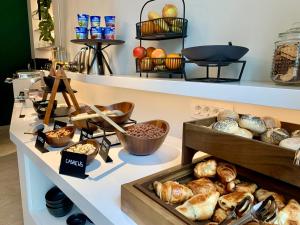 a bakery with bread and other baked goods on shelves at Bloom Hotel in Ljubljana
