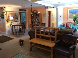 a living room with a couch and a dog in it at Mancos Inn in Mancos