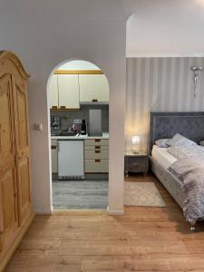 a kitchen and a bedroom with a bed in a room at Boutique Haus Sissi in Füssen