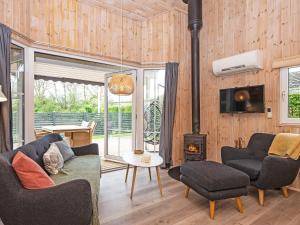 a living room with a couch and chairs and a fireplace at 4 person holiday home in Hemmet in Hemmet