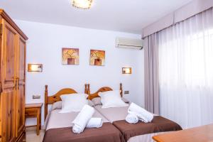 a bedroom with two beds with white pillows at Miramar in Carboneras +39 photos