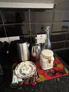 a counter top with a plate and other kitchen items at John Street Apartments Flat 2 in Bristol
