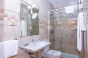 a bathroom with a sink and a toilet and a shower at Miramar in Carboneras