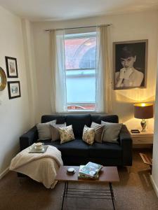 a living room with a couch and a window at John Street Apartments Flat 2 in Bristol