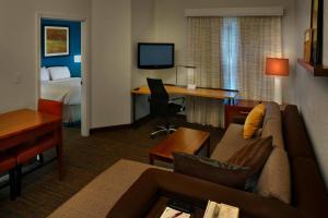 a hotel room with a couch and a desk and a bed at Residence Inn Danbury in Danbury