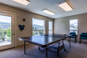 a ping pong table in a room with windows at Park Pointe Lago Vita C104 in Chelan