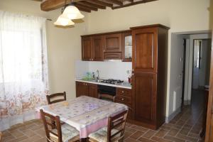 a kitchen with a table and a sink and a counter at La Casa del Falegname in Umbertide