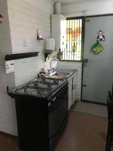 eine Küche mit Herd und Spüle in der Unterkunft Casa full amoblada: 3 dormitorios + estacionamiento in Coquimbo