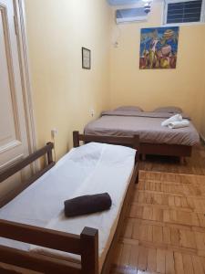 two twin beds in a room with at Hostel ERA in Tbilisi City