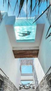a swimming pool in the middle of a building at TULUM Beachfront Villa Kiin in Tulum