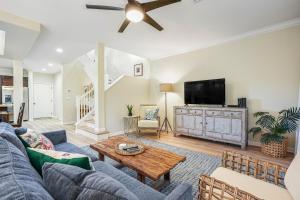 a living room with a couch and a tv at Nihilani at Princeville 19C in Princeville