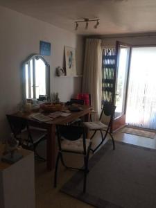 a room with a wooden table with chairs and a window at Apartamentos Clipper Llafranc Costa Brava in Llafranc