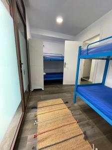 a room with two bunk beds and a mirror at Vagabond Vieiras Beds & Dinner Albergue in La Portela de Valcarce