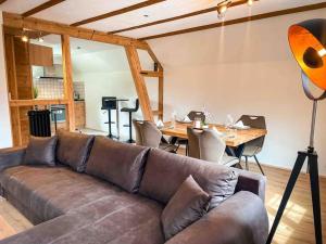 a living room with a couch and a table with chairs at Alpine Chalet in Kandersteg