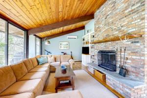 a living room with a couch and a fireplace at Bijha's View in Chilmark