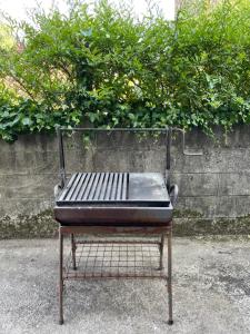 a metal bench sitting in front of a wall at Casa Malvina in A Coruña