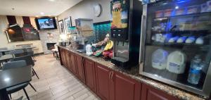 a bar in a restaurant with a refrigerator at Super 8 by Wyndham Sterling Heights/Detroit Area in Sterling Heights