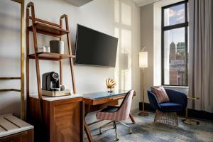 a hotel room with a desk and a tv at Rand Tower Hotel, Minneapolis, a Tribute Portfolio Hotel in Minneapolis