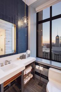 a bathroom with a sink and a window at Rand Tower Hotel, Minneapolis, a Tribute Portfolio Hotel in Minneapolis