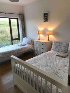 a bedroom with two beds and a window at Coast Lodge - Family vacation in Mulranny