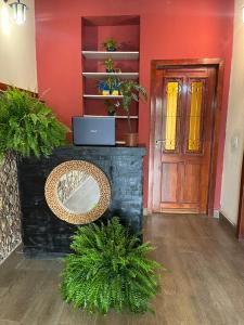 a room with a door and a table and some plants at Rio Hostel 40 Graus in Rio de Janeiro