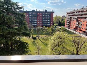 a view of a park in a city with buildings at Casa della Commenda in Segrate