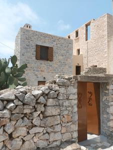 a stone building with a stone wall at kir-Yiannis stonehouse @Areopoli in Areopoli