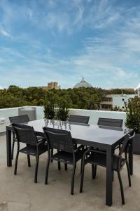 a table and chairs on top of a roof at Idyllic Apartment close to Valletta in Il-Furjana