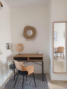 a desk with a chair and a mirror in a room at kir-Yiannis stonehouse @Areopoli in Areopoli