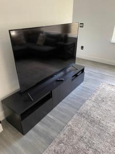 a large black entertainment center in a living room at BellaVida Orlando in Kissimmee