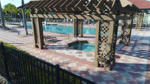 a pergola with a swimming pool in a resort at BellaVida Orlando in Kissimmee