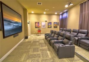 a waiting room with couches and a flat screen tv at BellaVida Orlando in Kissimmee
