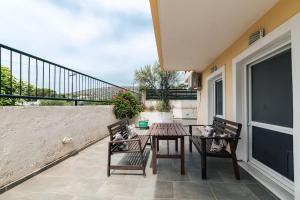 a patio with two chairs and a table and a table and chairs at George residence Attica Riviera in Kalívia Thorikoú