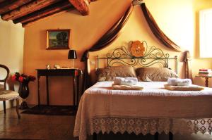 a bedroom with a bed with two pillows on it at Altana Panoramic in Lucca