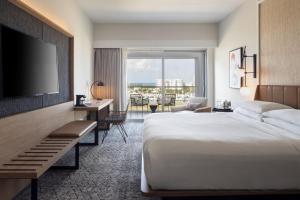 a hotel room with a bed and a flat screen tv at Sheraton Puerto Rico Resort & Casino in San Juan