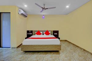 a bedroom with a large bed with red pillows at Ab7 Residency Near Miraj Cinemas - Shalini Shivani in Hyderabad