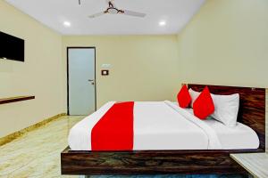 a bedroom with a large bed with red pillows at Ab7 Residency Near Miraj Cinemas - Shalini Shivani in Hyderabad
