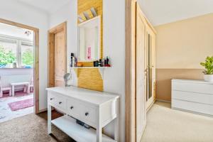 a white dresser in a room with a mirror at Familiengeeignete Ferienwohnung in Königs Wusterhausen +8 photos
