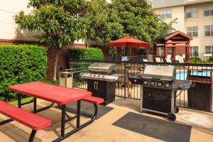 a patio with a grill and a picnic table and a barbecue at Residence Inn Arlington in Arlington