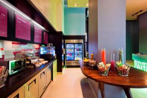 a kitchen with a wooden table in a restaurant at Aloft Manhattan Downtown - Financial District in New York